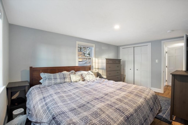 bedroom featuring baseboards, a closet, and wood finished floors