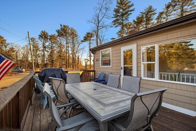 wooden terrace featuring outdoor dining space