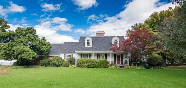 cape cod home with a front yard and a chimney