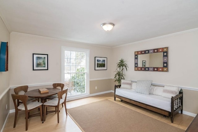 interior space featuring ornamental molding, light wood-style flooring, and baseboards