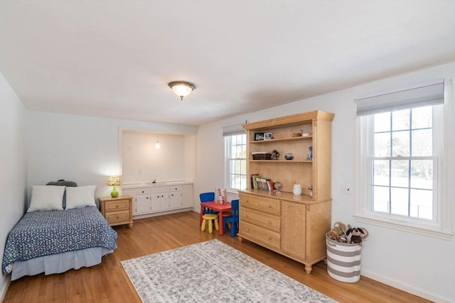 bedroom featuring baseboards and light wood-style floors