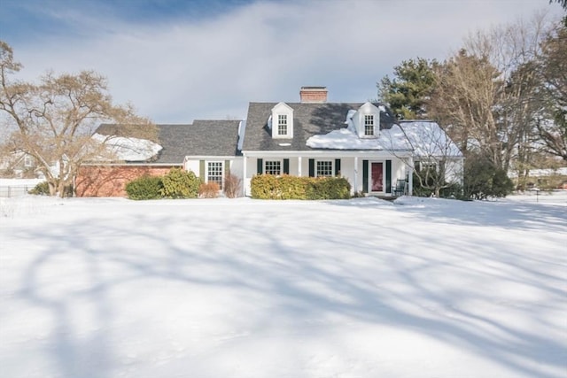 cape cod-style house featuring a chimney