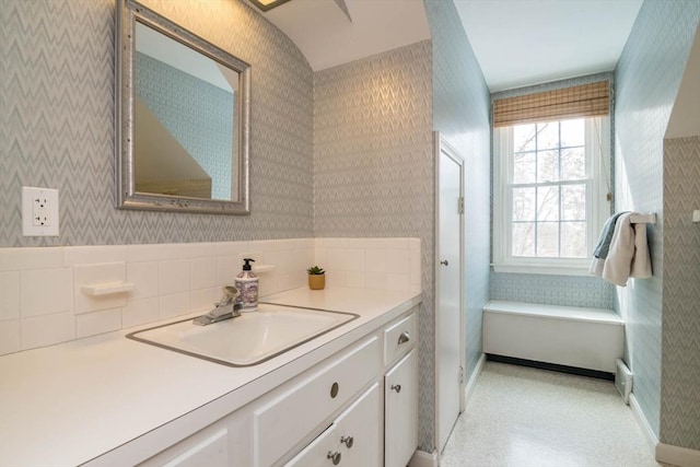 bathroom featuring wallpapered walls and vanity