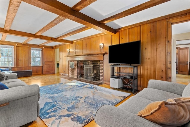 living room featuring beamed ceiling, a fireplace, and wooden walls