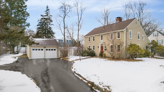 view of front of home with a garage and an outdoor structure