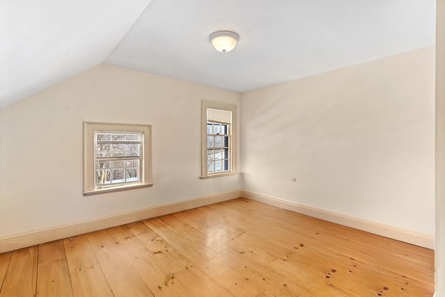 bonus room featuring wood-type flooring and vaulted ceiling