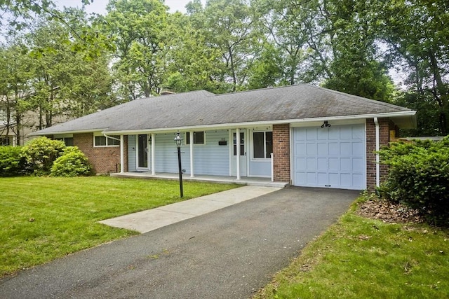 115 Carnavon Cir, Springfield, MA 01109 - single story home with an attached garage, a porch, brick siding, driveway, and a front lawn