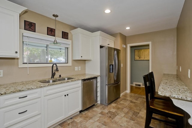 115 Carnavon Cir, Springfield, MA 01109 - kitchen featuring appliances with stainless steel finishes, white cabinetry, light stone countertops, stone finish floors, and recessed lighting