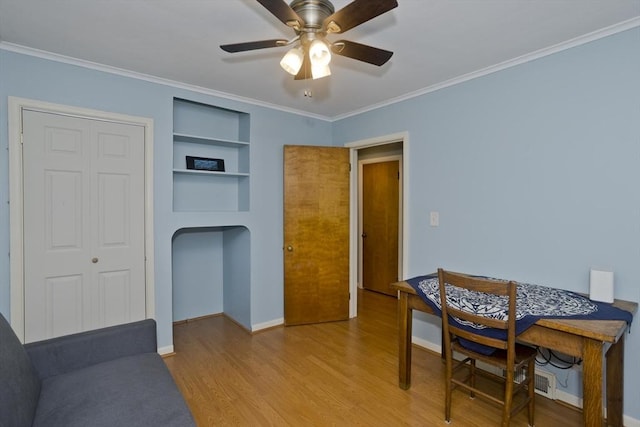 115 Carnavon Cir, Springfield, MA 01109 - dining room featuring wood finished floors, ornamental molding, ceiling fan, and built in shelves