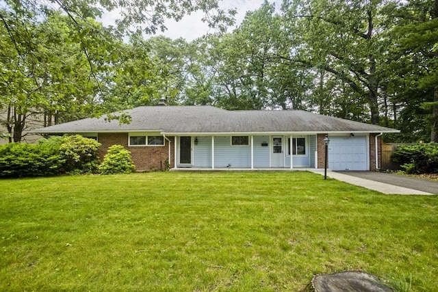 115 Carnavon Cir, Springfield, MA 01109 - ranch-style home with brick siding, an attached garage, a front lawn, and driveway
