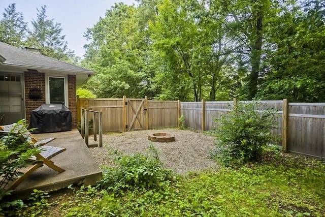 115 Carnavon Cir, Springfield, MA 01109 - fenced backyard featuring an outdoor fire pit