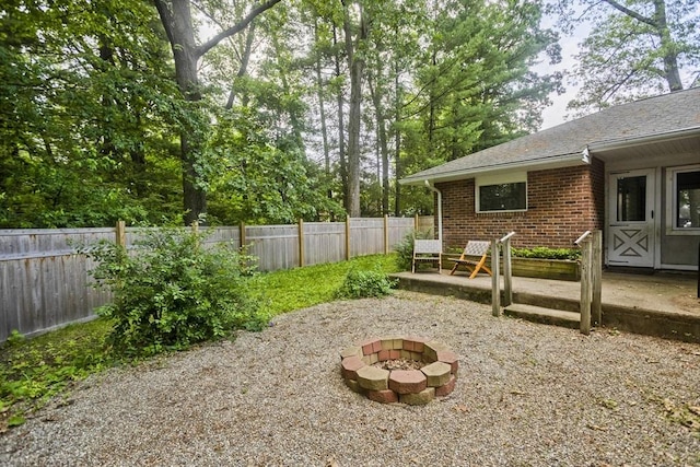 115 Carnavon Cir, Springfield, MA 01109 - fenced backyard featuring an outdoor fire pit