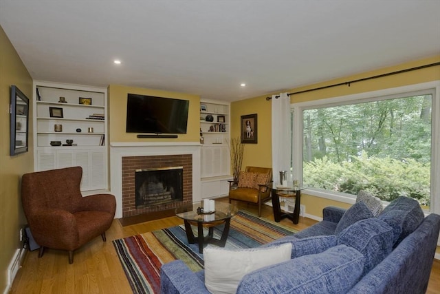 115 Carnavon Cir, Springfield, MA 01109 - living room with wood finished floors, a brick fireplace, and built in features