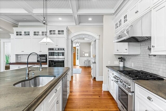 25 Wedgemere Ave, Winchester, MA 01890 - kitchen with appliances with stainless steel finishes, a sink, ornamental molding, light wood finished floors, and beamed ceiling