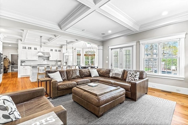 25 Wedgemere Ave, Winchester, MA 01890 - living room with coffered ceiling, light wood finished floors, beamed ceiling, ornamental molding, and ornate columns