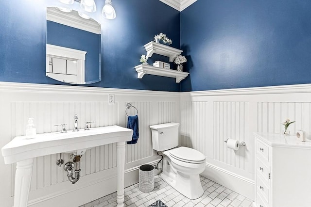 25 Wedgemere Ave, Winchester, MA 01890 - bathroom featuring toilet, a wainscoted wall, a decorative wall, and crown molding