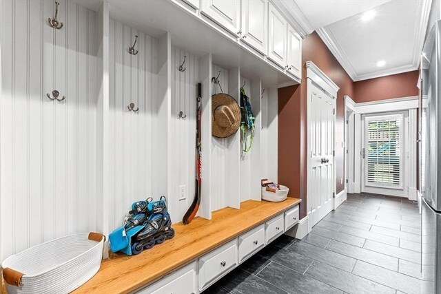 25 Wedgemere Ave, Winchester, MA 01890 - mudroom with ornamental molding and dark tile patterned floors