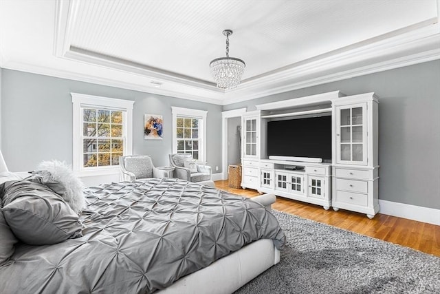 25 Wedgemere Ave, Winchester, MA 01890 - bedroom with a tray ceiling, ornamental molding, a chandelier, wood finished floors, and baseboards