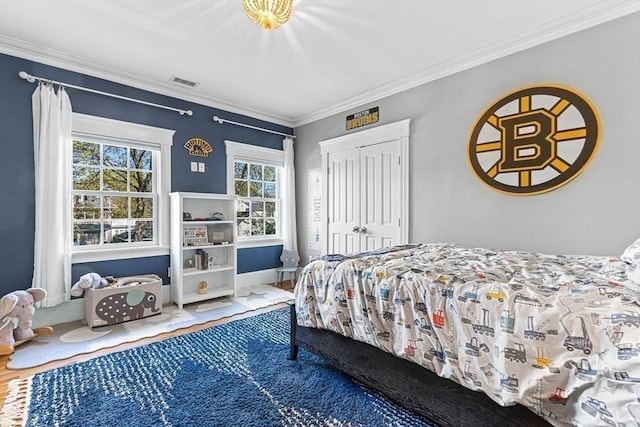 25 Wedgemere Ave, Winchester, MA 01890 - bedroom featuring wood finished floors, ornamental molding, a closet, and baseboards