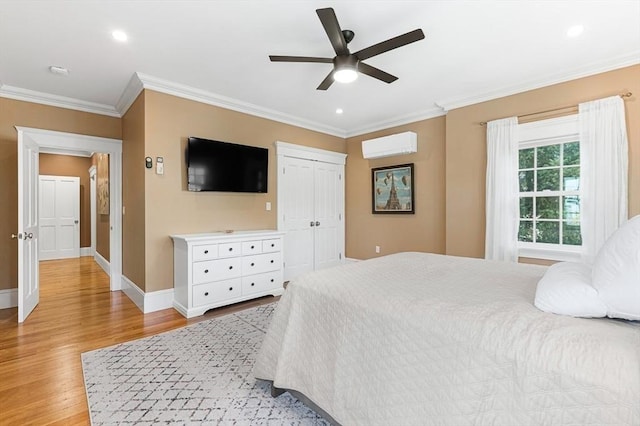 25 Wedgemere Ave, Winchester, MA 01890 - bedroom with a wall mounted AC, light wood-type flooring, ornamental molding, baseboards, and ceiling fan