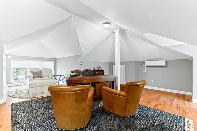 25 Wedgemere Ave, Winchester, MA 01890 - sitting room featuring wood finished floors, baseboards, a wall mounted air conditioner, and lofted ceiling