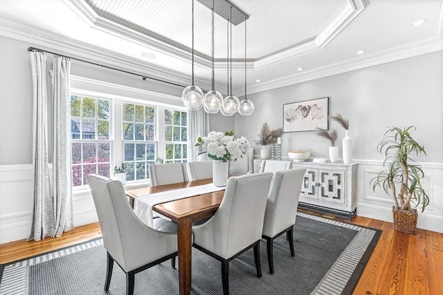 25 Wedgemere Ave, Winchester, MA 01890 - dining area featuring a raised ceiling, ornamental molding, wood finished floors, a wainscoted wall, and a decorative wall