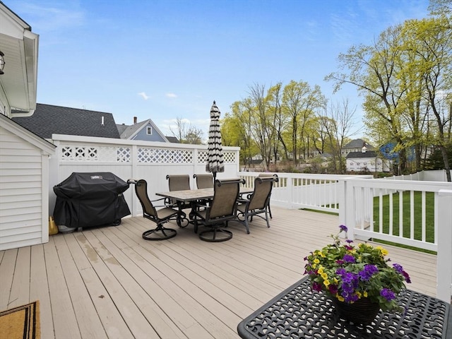 deck featuring fence, outdoor dining space, and a grill