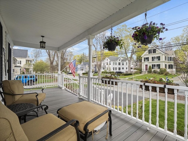 wooden terrace with a residential view and a porch