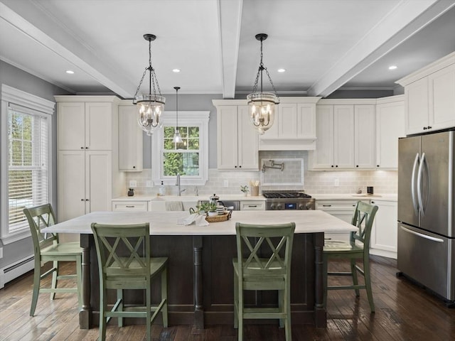 kitchen featuring freestanding refrigerator, an inviting chandelier, and ornamental molding
