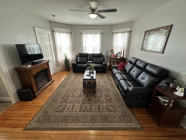 144-146 Irving St, Fall River, MA 02723 - living area with wood finished floors, ceiling fan, plenty of natural light, and a glass covered fireplace