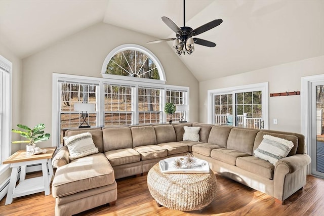 living area with a ceiling fan, high vaulted ceiling, and wood finished floors