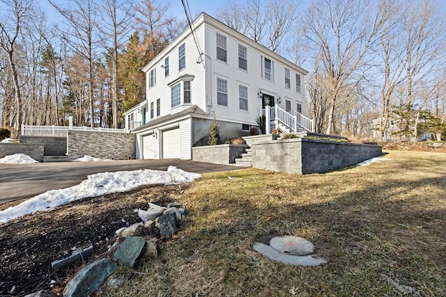 view of side of home featuring a garage and driveway