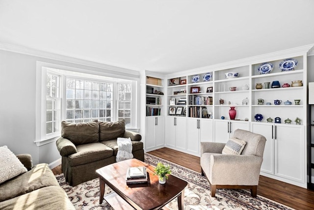 living area with crown molding and wood finished floors