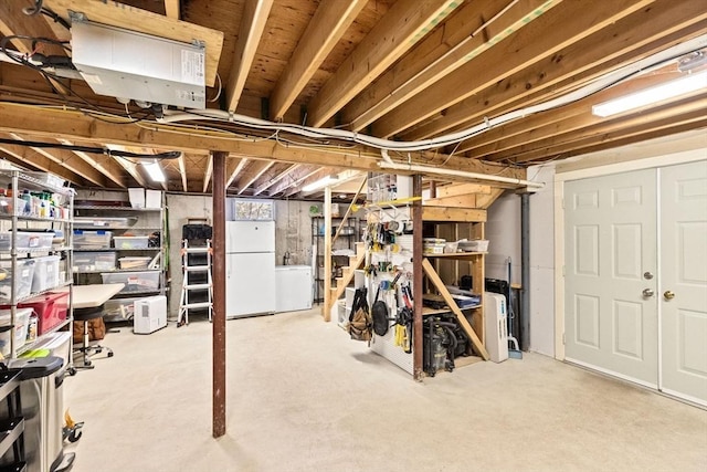 unfinished basement featuring freestanding refrigerator