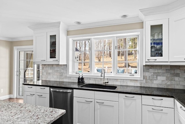 kitchen featuring a sink, white cabinetry, ornamental molding, a wealth of natural light, and dishwasher