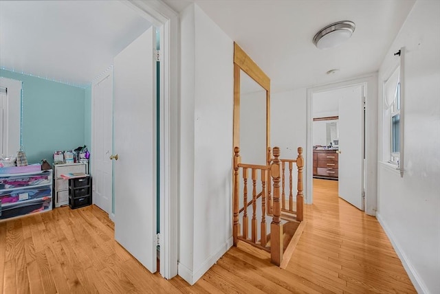 11 Murphy Ct, Newton, MA 02458 - hallway with an upstairs landing, light wood finished floors, and baseboards