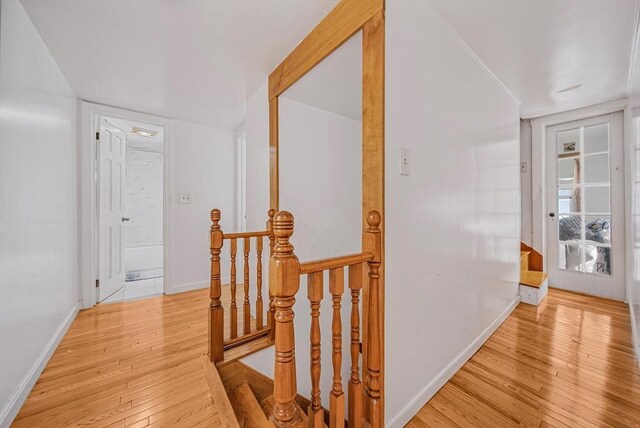 11 Murphy Ct, Newton, MA 02458 - hall featuring an upstairs landing, light wood finished floors, and baseboards