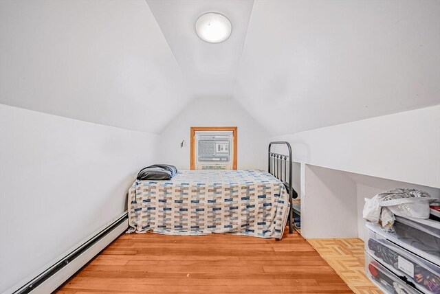 11 Murphy Ct, Newton, MA 02458 - bedroom with baseboard heating, vaulted ceiling, and wood finished floors