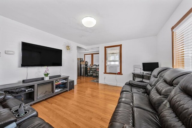 11 Murphy Ct, Newton, MA 02458 - living area with light wood-style flooring, cooling unit, and baseboards