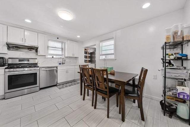 11 Murphy Ct, Newton, MA 02458 - kitchen featuring stainless steel appliances, under cabinet range hood, plenty of natural light, white cabinetry, and recessed lighting
