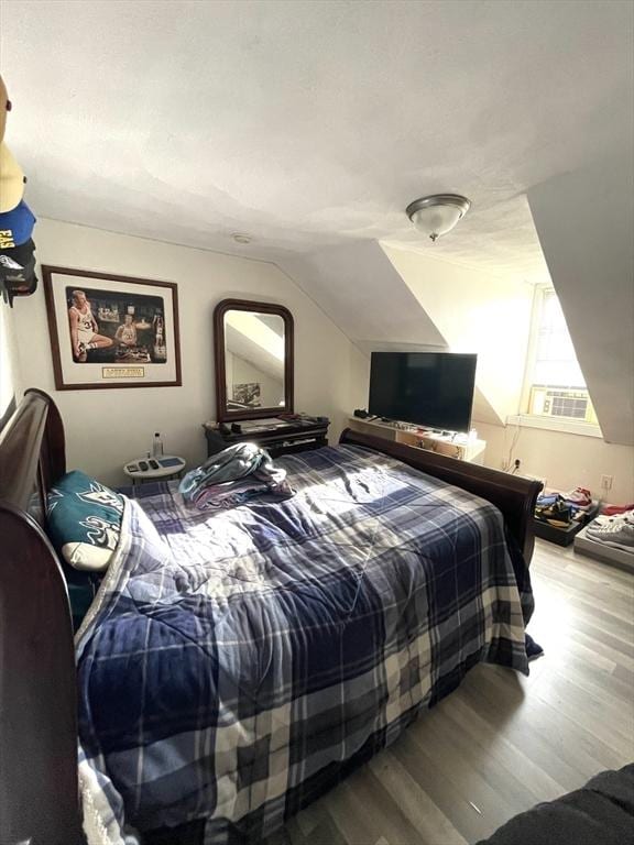 bedroom featuring vaulted ceiling and hardwood / wood-style floors