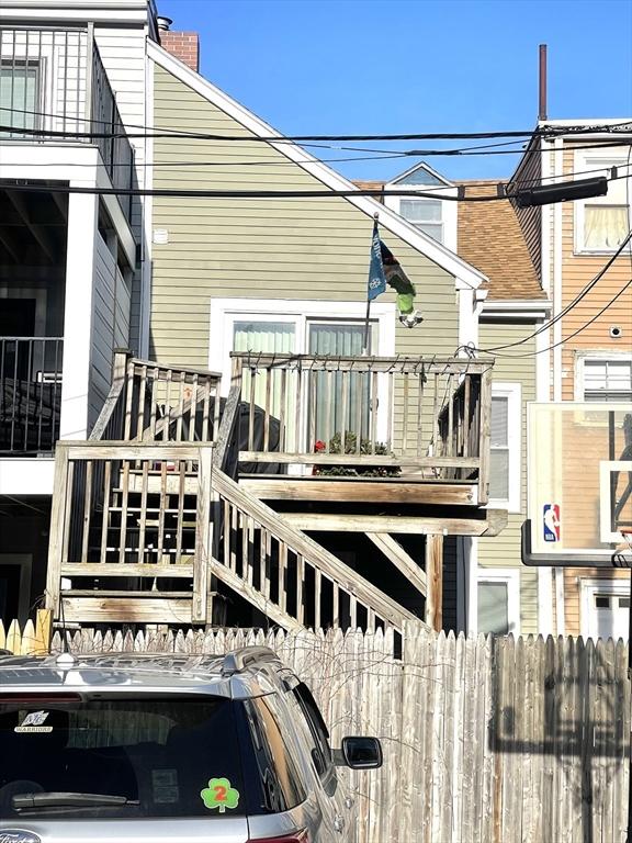 back of property with a balcony