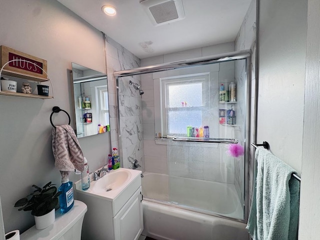 full bathroom featuring vanity, toilet, and combined bath / shower with glass door