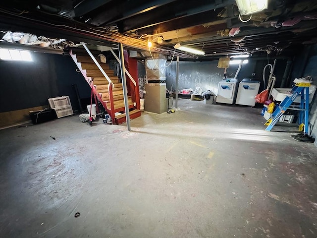 basement featuring independent washer and dryer and heating unit