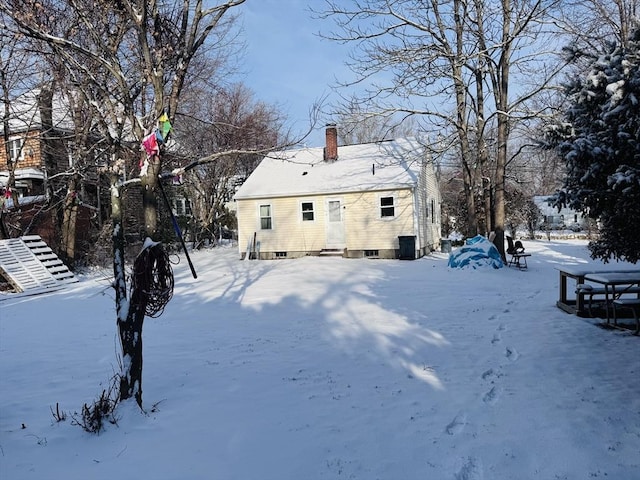 view of snow covered back of property