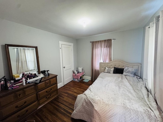 bedroom with dark hardwood / wood-style flooring