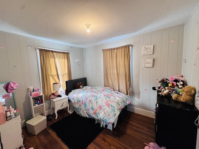 bedroom with dark wood-type flooring