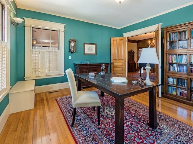 office area with crown molding, a chandelier, and light hardwood / wood-style flooring