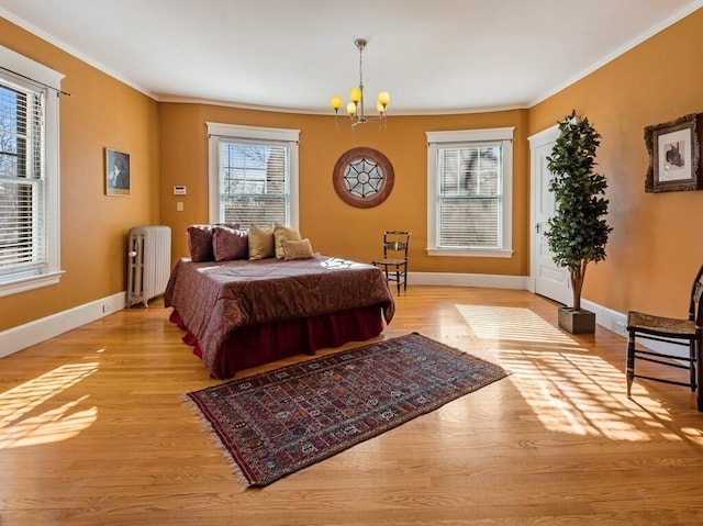 bedroom with ornamental molding, radiator, a chandelier, and light hardwood / wood-style flooring