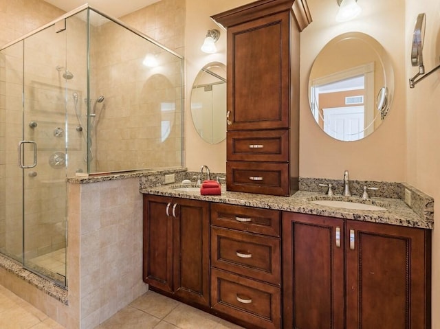 bathroom with walk in shower, vanity, and tile patterned flooring